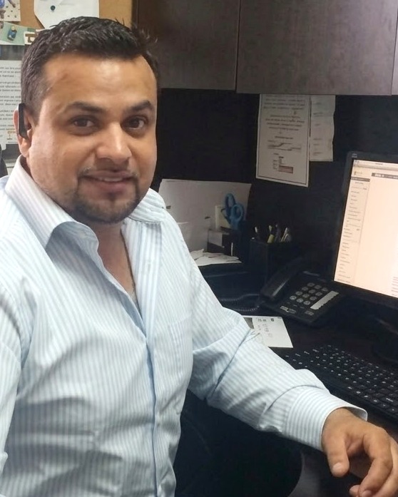Paul at his desk, smiling.